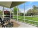 Relaxing screened porch features outdoor seating with a view of the backyard at 557 Luther Dr, Iron Station, NC 28080