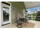 Relaxing screened-in porch featuring a stone fireplace and comfortable seating area at 557 Luther Dr, Iron Station, NC 28080
