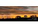 The sky is set ablaze with a striking sunset, painting the horizon with bands of color at 557 Luther Dr, Iron Station, NC 28080