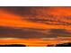 A fiery sunset illuminates the sky with a beautiful gradient of orange and red hues at 557 Luther Dr, Iron Station, NC 28080