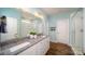A stylish bathroom with double sinks, a granite countertop, and a walk-in shower at 7035 Butternut Oak Ter, Huntersville, NC 28078