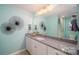 Stylish bathroom featuring a granite countertop vanity and decorative wall art at 7035 Butternut Oak Ter, Huntersville, NC 28078