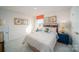A neutral guest bedroom is designed with natural-wood decor and features great light at 7035 Butternut Oak Ter, Huntersville, NC 28078