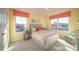Bright bedroom features colorful decor, a cozy sitting area, and an abundance of natural light at 7035 Butternut Oak Ter, Huntersville, NC 28078