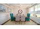 Formal dining room featuring stylish chairs, modern lighting fixture, and large window with natural light at 7035 Butternut Oak Ter, Huntersville, NC 28078