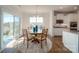 Bright dining area features wood floors and a round table with seating and a sliding glass door at 7035 Butternut Oak Ter, Huntersville, NC 28078