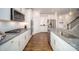 Gourmet kitchen boasting stainless steel appliances, granite countertops, and sleek white cabinetry at 7035 Butternut Oak Ter, Huntersville, NC 28078
