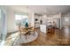A modern kitchen boasts white cabinets, stainless steel appliances, and a center island with bar seating at 7035 Butternut Oak Ter, Huntersville, NC 28078