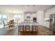 Open-concept kitchen featuring stainless steel appliances, granite countertops, and a breakfast bar with seating at 7035 Butternut Oak Ter, Huntersville, NC 28078