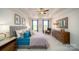 Spacious main bedroom with tray ceilings, plush bedding, and ample closet space at 7035 Butternut Oak Ter, Huntersville, NC 28078