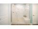 Spa-like bathroom with white tile, a glass-enclosed shower, and a built-in bench at 7035 Butternut Oak Ter, Huntersville, NC 28078