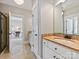Modern bathroom with tiled floors, cabinets, and a view into a bedroom at 7208 Ashton Gate Dr, Charlotte, NC 28270