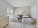 Comfortable bedroom with twin beds, a dresser, and natural light at 7208 Ashton Gate Dr, Charlotte, NC 28270