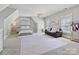 Spacious bedroom featuring a large area rug, ample natural light, and stylish furniture at 7208 Ashton Gate Dr, Charlotte, NC 28270