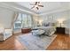 Well-lit bedroom featuring hardwood floors, tray ceiling, and large windows at 7208 Ashton Gate Dr, Charlotte, NC 28270