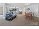 Spacious bonus room with home gym equipment, a table, and a computer desk at 7208 Ashton Gate Dr, Charlotte, NC 28270