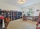 Bonus room with carpet flooring, and bookshelves and a desk area with lots of natural light at 7208 Ashton Gate Dr, Charlotte, NC 28270
