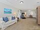Large bonus room with workout equipment and a cozy seating area with a white couch at 7208 Ashton Gate Dr, Charlotte, NC 28270