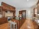 Well-equipped kitchen with a center island, stainless steel appliances, custom cabinetry, and hardwood floors at 7208 Ashton Gate Dr, Charlotte, NC 28270