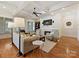 Comfortable living room featuring a fireplace, hardwood floors, coffered ceiling, and stylish furnishings at 7208 Ashton Gate Dr, Charlotte, NC 28270