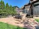Stamped concrete patio with wrought iron fence, mature trees, and outdoor dining set at 7208 Ashton Gate Dr, Charlotte, NC 28270