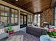 Cozy sunroom with brick floors, stone fireplace, and wicker furniture with plenty of seating at 7208 Ashton Gate Dr, Charlotte, NC 28270
