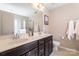 Bathroom with double sink vanity, a large mirror, neutral countertops and a glass enclosed shower at 78090 Rillstone Dr, Lancaster, SC 29720