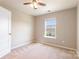 Bright bedroom with neutral carpet and paint and a large window at 78090 Rillstone Dr, Lancaster, SC 29720