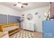 Well-decorated Bedroom with crib, dresser, and playful wall decor at 78090 Rillstone Dr, Lancaster, SC 29720