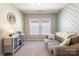 Inviting bedroom featuring sofa, cabinet, and stylish wallpaper design at 78090 Rillstone Dr, Lancaster, SC 29720