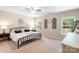 Bright bedroom featuring a metal bed frame, two side tables, and an abundance of natural light at 78090 Rillstone Dr, Lancaster, SC 29720