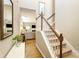 Hallway with staircase and wood floors leading to a living room with a fireplace and comfortable seating at 78090 Rillstone Dr, Lancaster, SC 29720