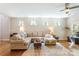 Spacious living room with hardwood floors, lots of natural light, and a comfortable sectional sofa at 78090 Rillstone Dr, Lancaster, SC 29720