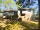 A backyard view of the home with a full back deck and partially exposed foundation at 8000 Briardale Dr, Charlotte, NC 28212