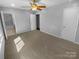 Bedroom with neutral colored walls, ceiling fan, and ensuite bathroom at 8000 Briardale Dr, Charlotte, NC 28212