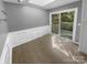 Bright room with wainscoting, sliding glass doors to the deck and neutral tile flooring at 8000 Briardale Dr, Charlotte, NC 28212