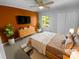 Cozy staged bedroom with ample natural light, a ceiling fan, closet, and a queen-size bed at 8000 Briardale Dr, Charlotte, NC 28212