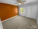 Inviting staged bedroom with modern ceiling fan, ample natural light, cozy carpet, and closet at 8000 Briardale Dr, Charlotte, NC 28212