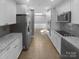 Bright, modern kitchen featuring stainless steel appliances, granite countertops, and custom cabinetry at 8000 Briardale Dr, Charlotte, NC 28212
