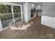 Modern kitchen with sliding glass door to a deck, stainless steel appliances, and white cabinets at 8000 Briardale Dr, Charlotte, NC 28212
