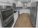 Well-equipped kitchen with stainless steel appliances, granite countertops, and sleek white cabinetry at 8000 Briardale Dr, Charlotte, NC 28212