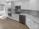 Modern kitchen featuring stainless steel appliances, granite countertops, and white cabinetry at 8000 Briardale Dr, Charlotte, NC 28212