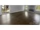Spacious living room with wood floors, natural light, and stone fireplace, perfect for gatherings at 8000 Briardale Dr, Charlotte, NC 28212