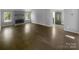 Spacious living room with a stone fireplace and hardwood floors, perfect for entertaining at 8000 Briardale Dr, Charlotte, NC 28212