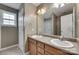 Bathroom featuring dual sinks, a large mirror, and a doorway to the shower at 835 Holdcroft Ln, Rock Hill, SC 29730