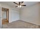 Bedroom featuring neutral carpet, a ceiling fan, double door closet, and an entrance to the bathroom at 835 Holdcroft Ln, Rock Hill, SC 29730