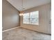 Cozy dining area with modern chandelier lighting and tile flooring at 835 Holdcroft Ln, Rock Hill, SC 29730