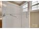 Shower featuring glass doors, shelving, and grab bars at 835 Holdcroft Ln, Rock Hill, SC 29730