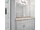 Modern bathroom vanity with marble countertop, white cabinets and large mirror, next to a shower at 913 Van Every St, Charlotte, NC 28205