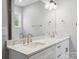 Bright bathroom featuring a double vanity with white marble counters and modern fixtures at 913 Van Every St, Charlotte, NC 28205